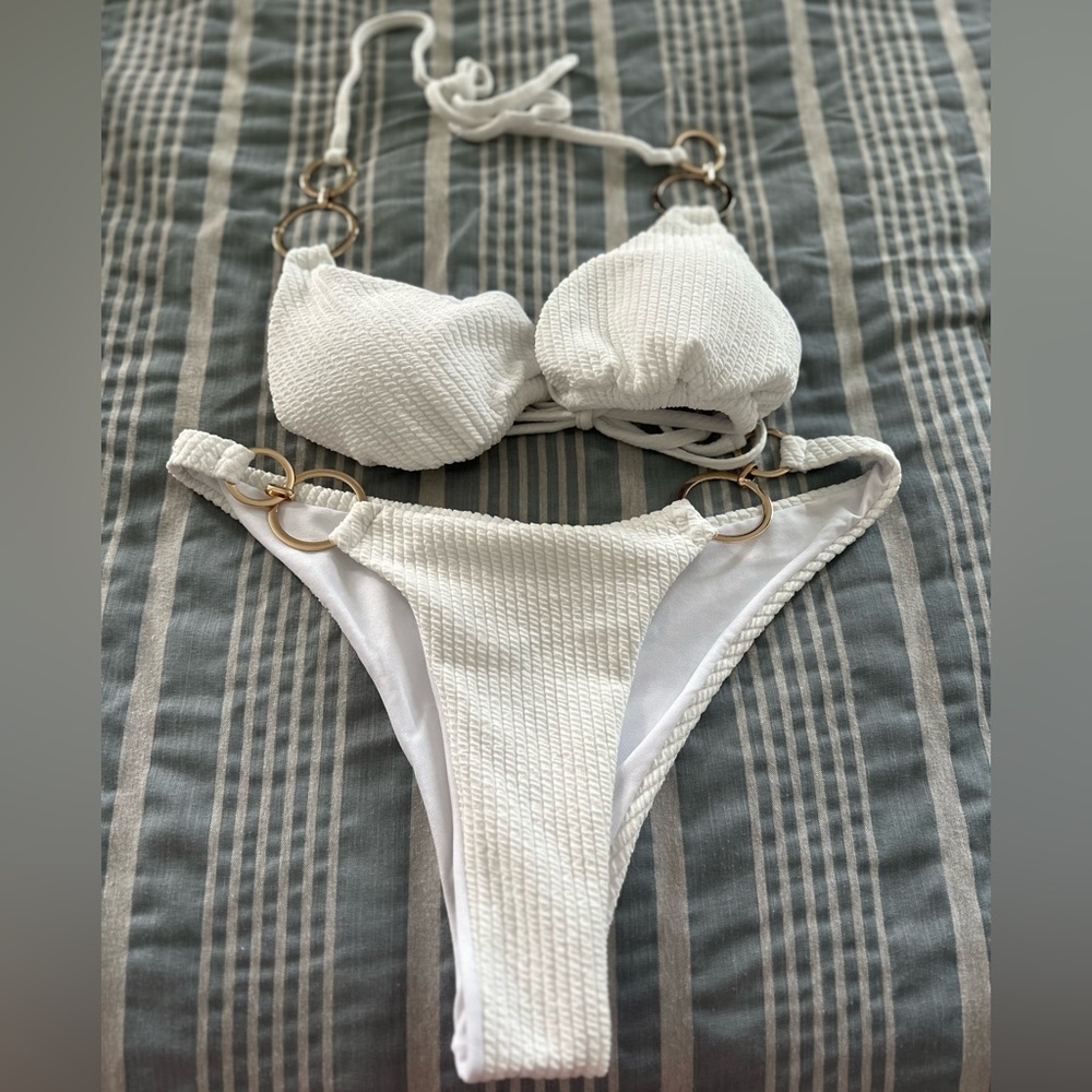 White bikini swimsuit with gold chain attached making it very desirable and sexy